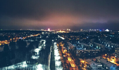 Top view of the night winter city with lights and lanterns