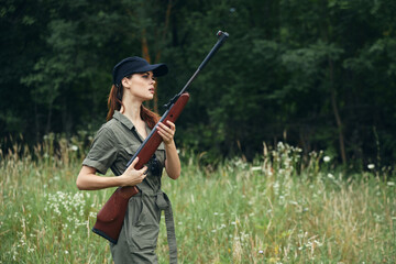 Woman on outdoor arms in green jumpsuit travel lifestyle fresh air 