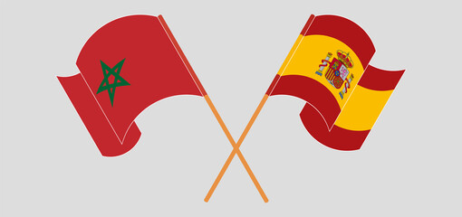 Crossed and waving flags of Morocco and Spain