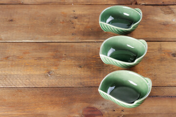 Fototapeta na wymiar green bowl on wooden table