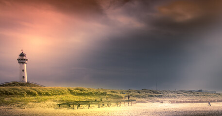 Lighthouse at sunrise on the beach