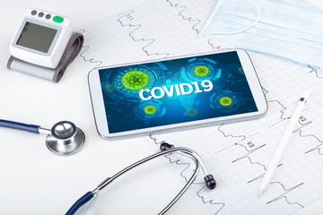 Close-up view of a tablet pc with COVID19 inscription, microbiology concept