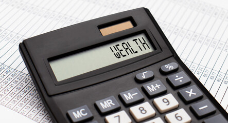 A calculator with the word WEALTH on the display