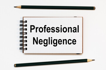 WHITE SPIRAL NOTEBOOK, TWO PENCILS WITH TEXT PROFESSIONAL NEGLIGENCE