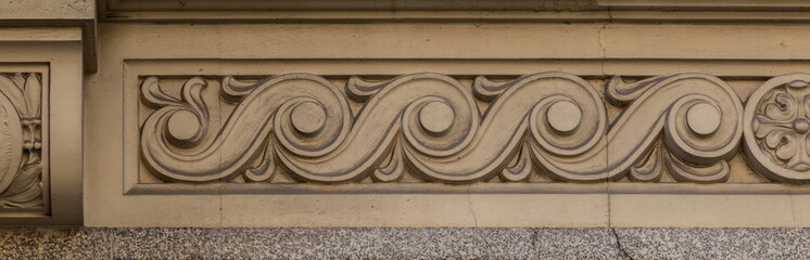 Elements of architectural decorations of buildings, gypsum stucco, wall texture, plaster molding and patterns. On the streets in Catalonia, public places. © Kozlik_mozlik