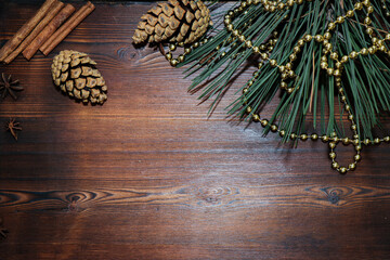 New year's background. Christmas decorations. Christmas toys and shiny beads. Wooden background. Holiday atmosphere. Pine branch