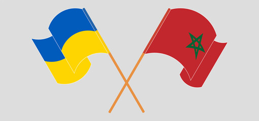 Crossed and waving flags of Ukraine and Morocco