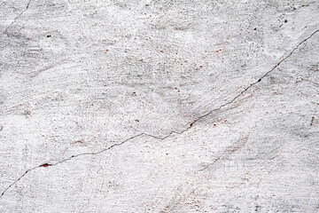 Texture of a concrete wall with cracks and scratches which can be used as a background