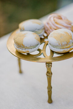 French Blue Macaroon Desserts On A Golden Stand