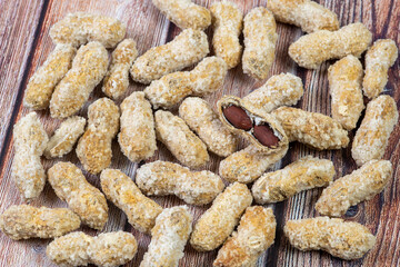 Salted healthy peanuts on a wooden surface