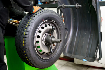 Mechanic balancing a car wheel. High quality photo