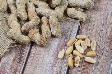 Salted healthy peanuts on a wooden surface