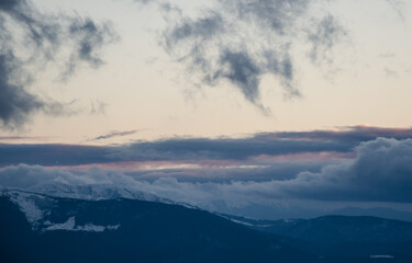 Fototapeta na wymiar Carpathian mountains winter. Snow coniferous forest at sunset.