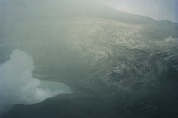 Crater Lake with smoke in Poas Volcano National Park