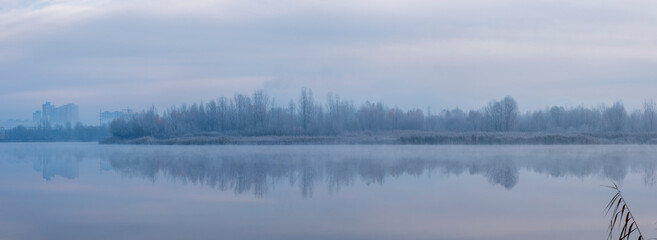 Obraz na płótnie Canvas Ukraine, Kyiv - 30 November 2020: Nebrezh Lake at the frozen mist morning weather