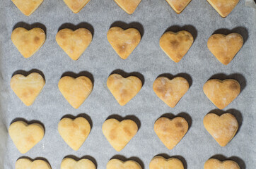 Homemade sweet cookies in the shape of hearts. Home comfort in the kitchen. Cooking with love