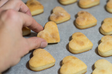 Fototapeta na wymiar Homemade sweet cookies in the shape of hearts. Home comfort in the kitchen. Cooking with love