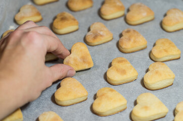 Homemade sweet cookies in the shape of hearts. Home comfort in the kitchen. Cooking with love
