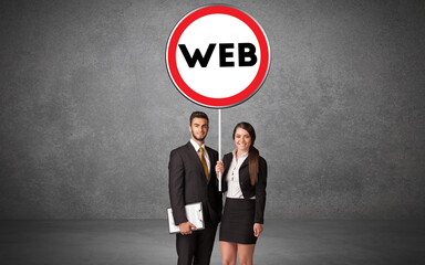 Young business person holdig traffic sign with WEB abbreviation, technology solution concept