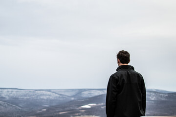 One man admiring the cold valley below