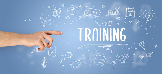 Close-Up of cropped hand pointing at TRAINING inscription, modern business solution concept
