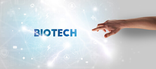 Hand pointing at BIOTECH inscription, modern technology concept