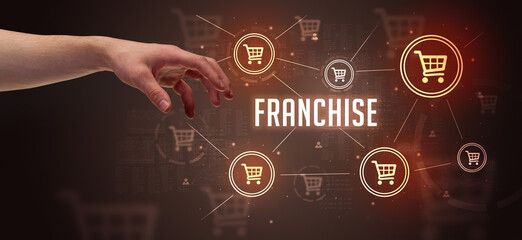 Close-Up of cropped hand pointing at FRANCHISE inscription, online shopping concept