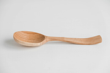 Empty wooden spoon on a white background. Copy, empty space for text