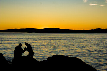 Naklejka na ściany i meble Lovers on the beach at the sunset
