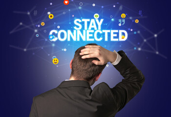Rear view of a businessman with STAY CONNECTED inscription, social networking concept