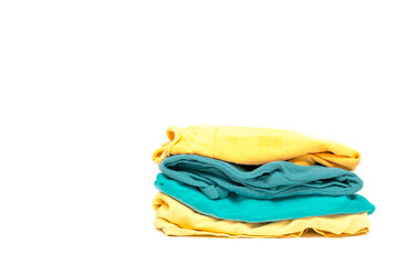 laundry pile of colorful clothing isolated. stack of trendy color clothes close up with copy space