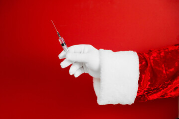 Santa hand with syringe, medical injection. Medicine equipment with needle. Liquid drug or drug....
