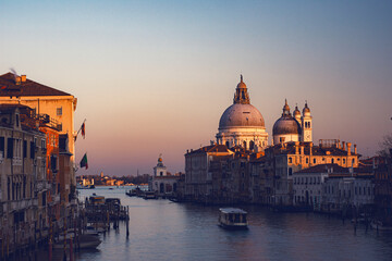 view of the Canal Grand and Basilica of Santa Maria della Salute from the Accademia bridge during covid 19 at sunset 