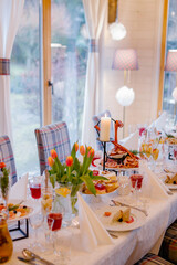 Festive wedding table setting with flowers, napkins, cutlery, glasses and candles, bright summer table decor. Wedding decor 