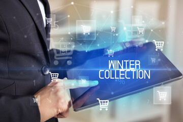 Young person makes a purchase through online shopping application with WINTER COLLECTION inscription
