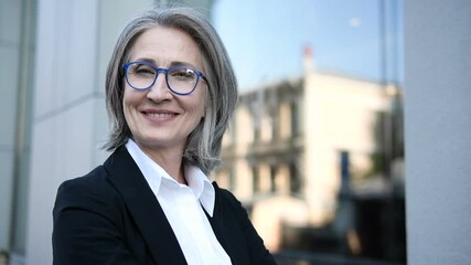 Successful senior business woman looking at camera, hiring employees to company