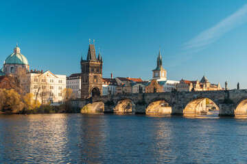 charles bridge over vltava river and blue sky at sunset in the center of prague
