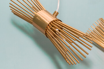 Switched off chandelier made of gold metal tube ceiling mount. Concept of interior decoration....