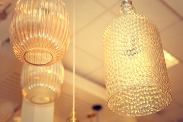 A group of switched-off ceiling chandelier with a transparent glass cover. Concept of interior...
