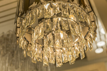 Close up of one luminous luxury expensive chandelier from a crystal ceiling lampshade. Classic...