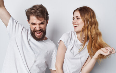 young couple in white t-shirts and jeans fun lifestyle isolated background