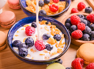 Muesli with berries and milk. Delicious healthy breakfast. Flakes and sweet pastries. High quality photo