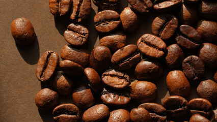 Coffee beans close up on a brown background. Coffee mood.