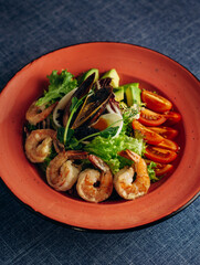 A healthy green garden salad with cooked shrimp, caviar and mussels