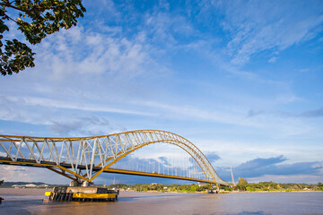 Fototapeta na wymiar Kutai Kartanegara Bridge, landmark and icon of Tenggarong City, Kutai Kartanegara, East Kalimantan. Build over Mahakam River to connect two sides of the city.