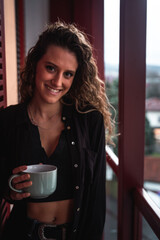 Young caucasian woman taking a break with a coffee at the terrace