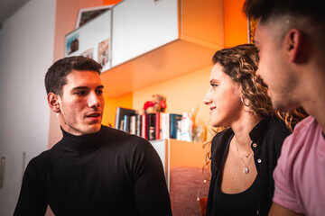 Three friends speaking at the sofa