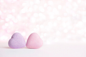 Valentines day greeting card , 2 pastel pink hearts on gentle pink background  with bokeh and place for text