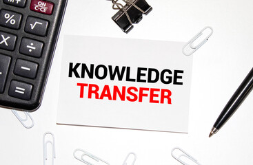 The card has a KNOWLEDGE TRANSFER label, a number of books, reports and a pen.