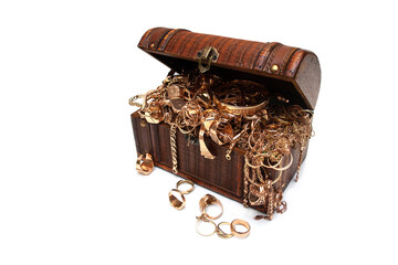 Treasure chest full of gold jewelry. Old used gold jewelry in a wooden box on white background.
